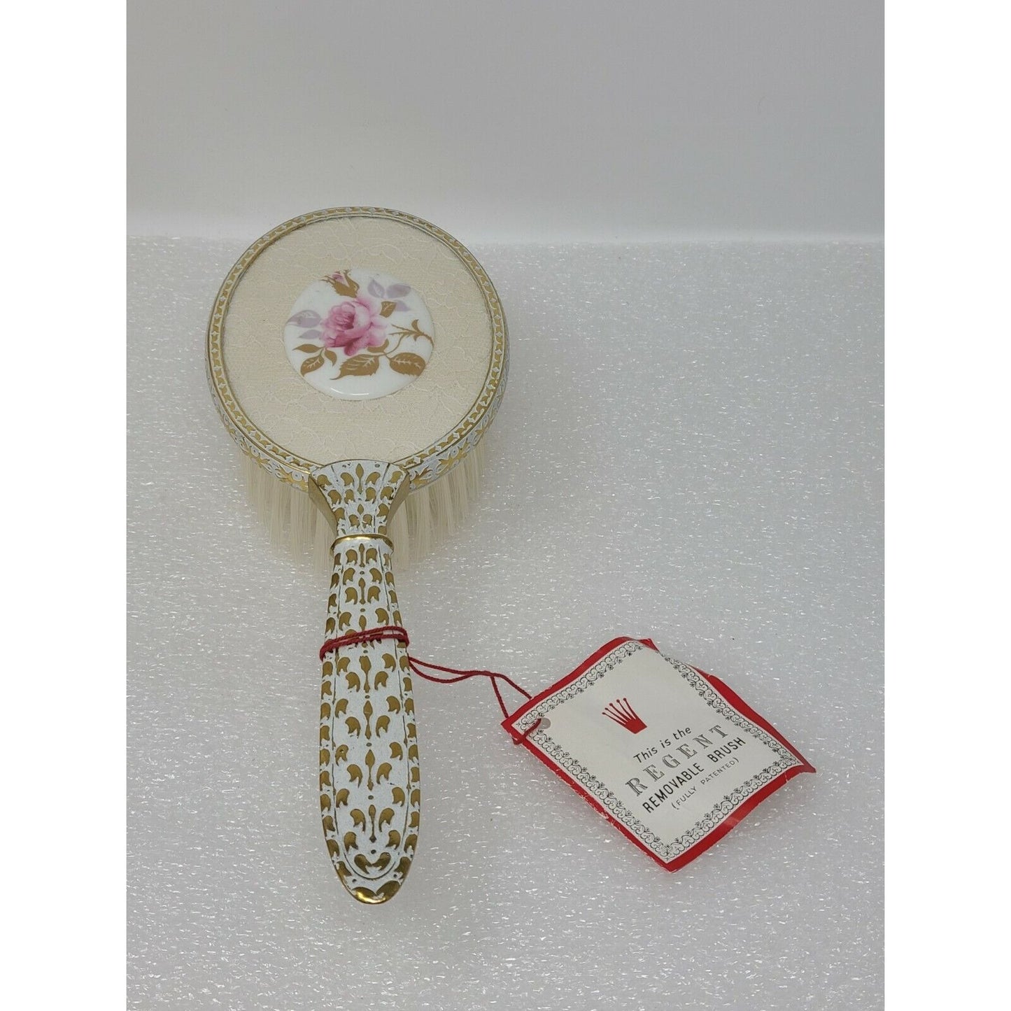 This is The Regent Removable Hair Brush Vanity White Lace / Pink Rose Gold Tone